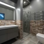 Sleek modern bathroom featuring a glass shower, floating vanity, and stylish decor.