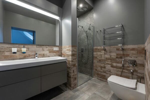 Sleek modern bathroom featuring a glass shower, floating vanity, and stylish decor.